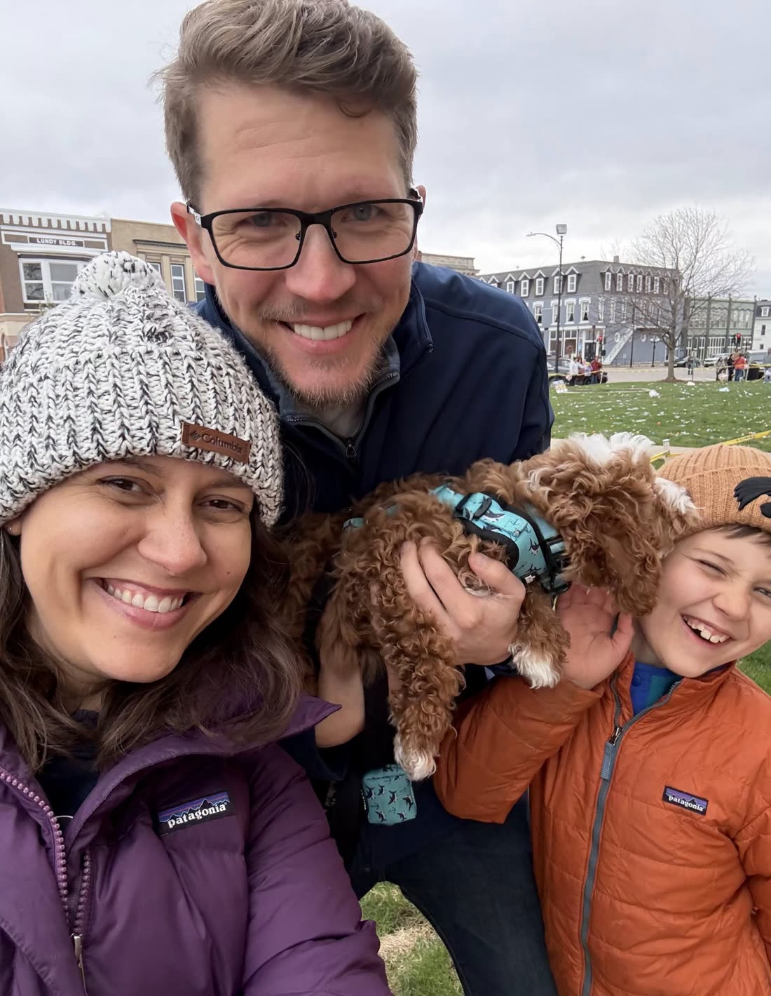 Brett Mohler with his wife, son, and their puppy on the Albia town square