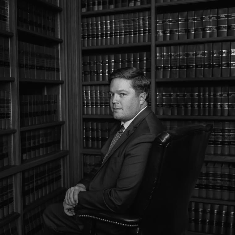 Portrait of Rep. Austin Harris seated in a law library
